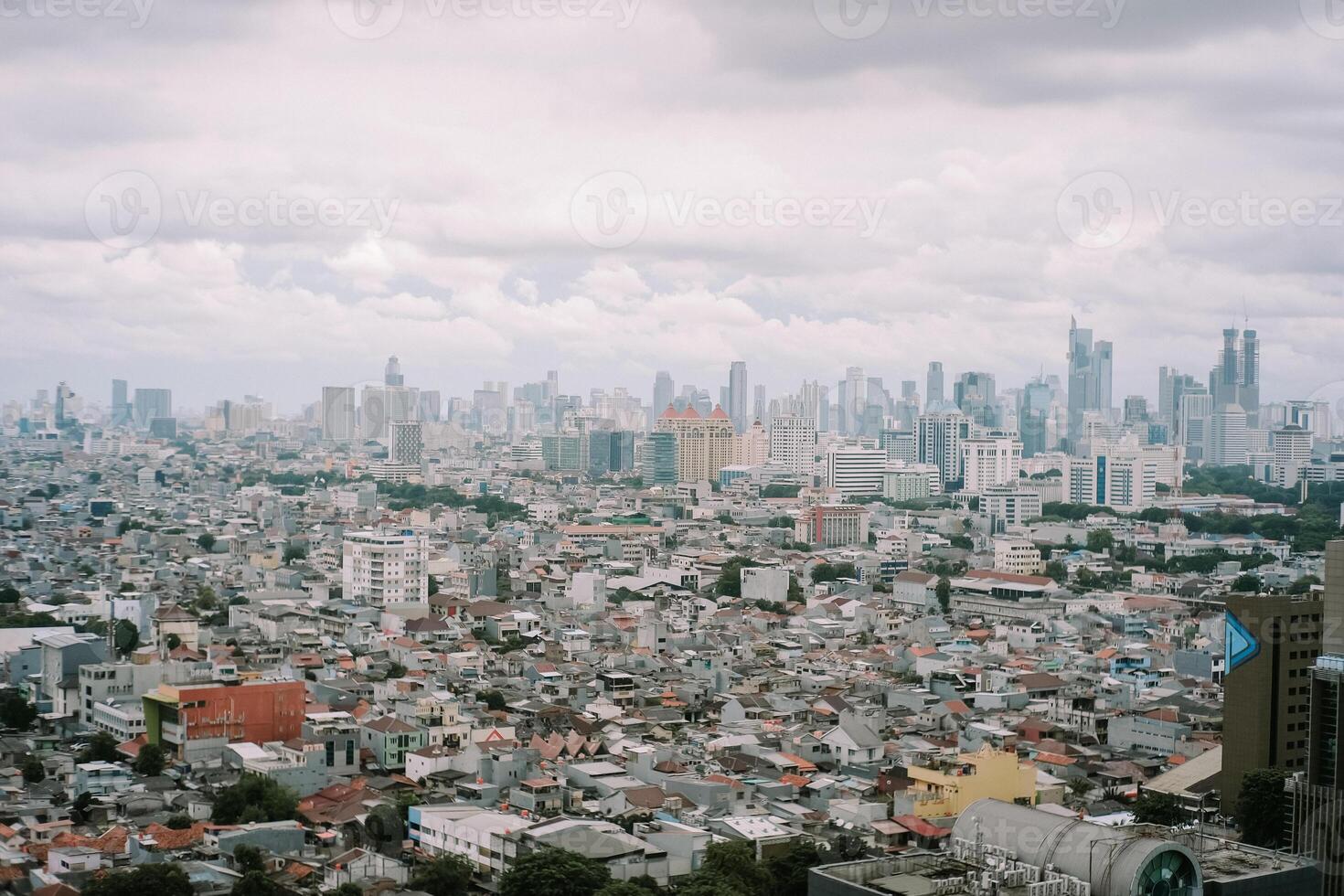 Jakarta cityscape view with densely packed houses under overcast sky photo