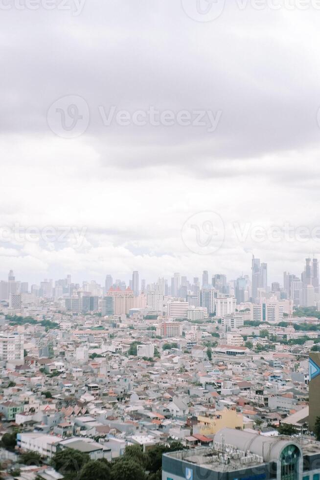 Overcast Urban Landscape featuring Dense Housing and City Skyline photo