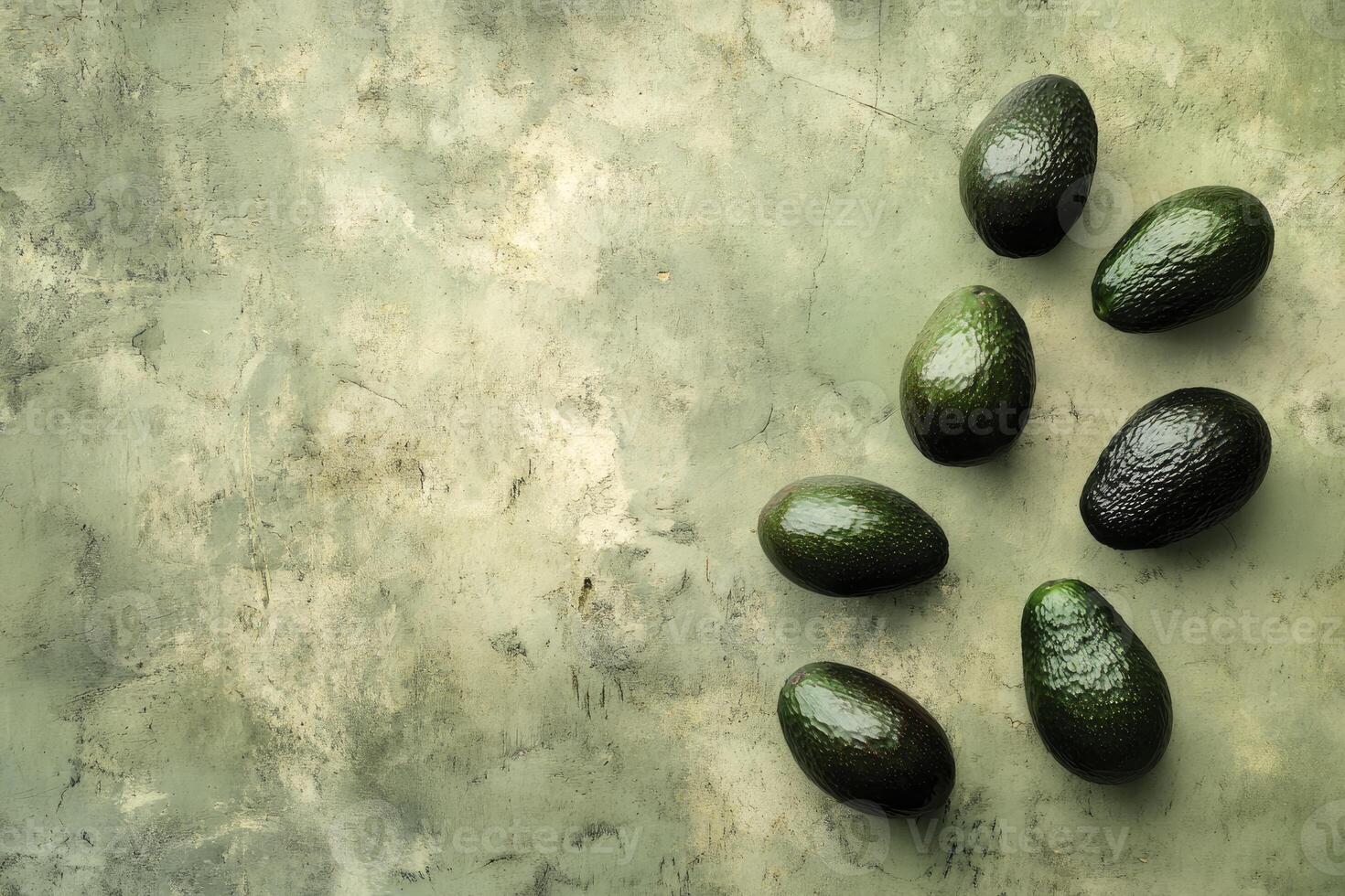 Avocado Still Life Arrangement on a Textured Green Surface Overhead Shot photo