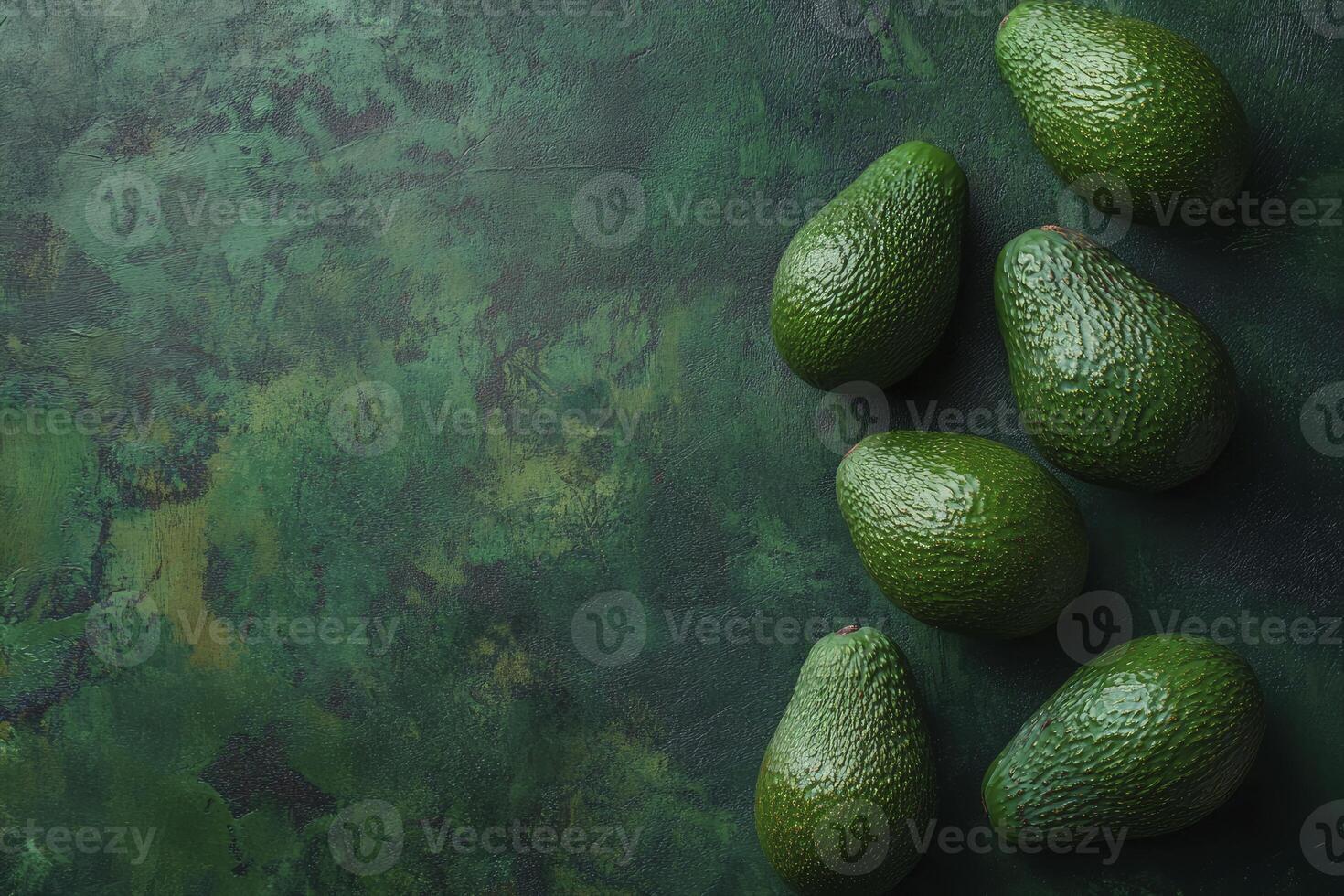 Fresh Avocados on a Dark Green Surface Creating a Natural Backdrop photo