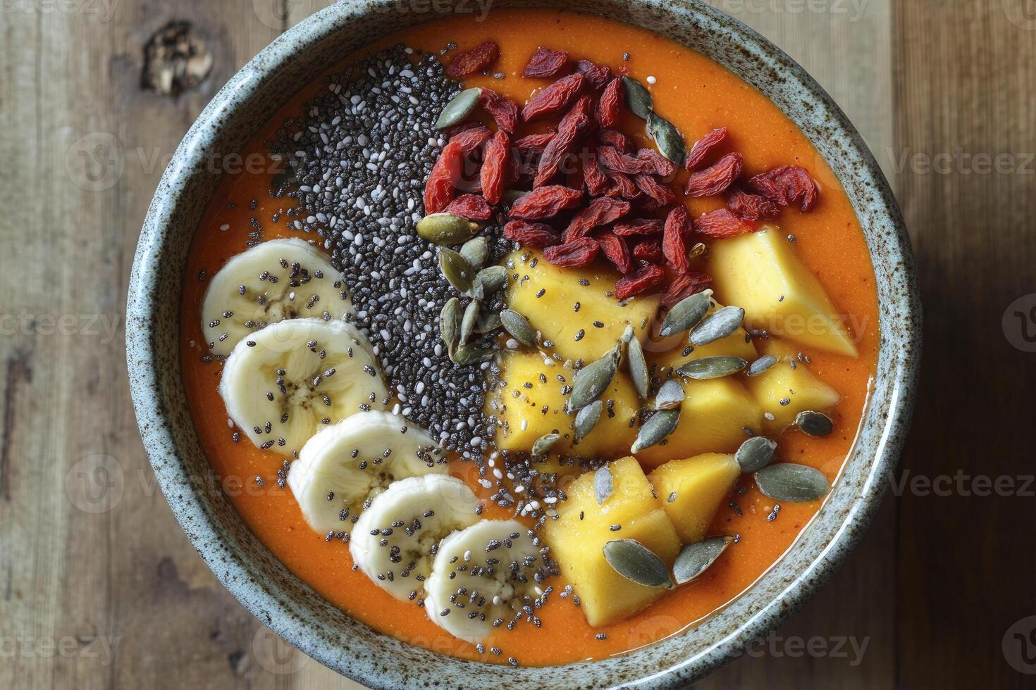 Enjoying a Fresh Fruit Smoothie Bowl with Banana Mango and Goji photo