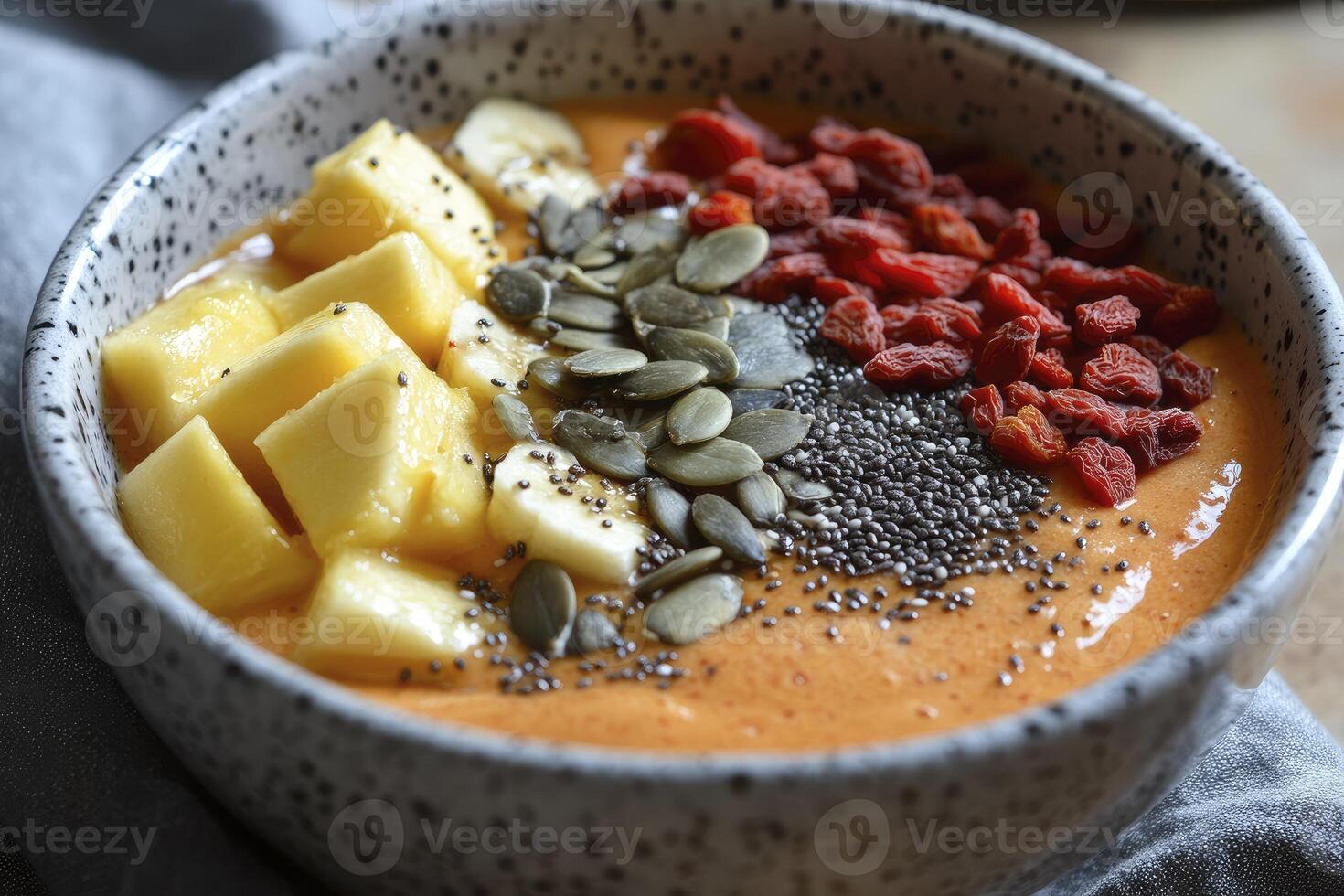Enjoying Delicious Smoothie Bowl with Mango Banana Goji Berries and Seeds photo