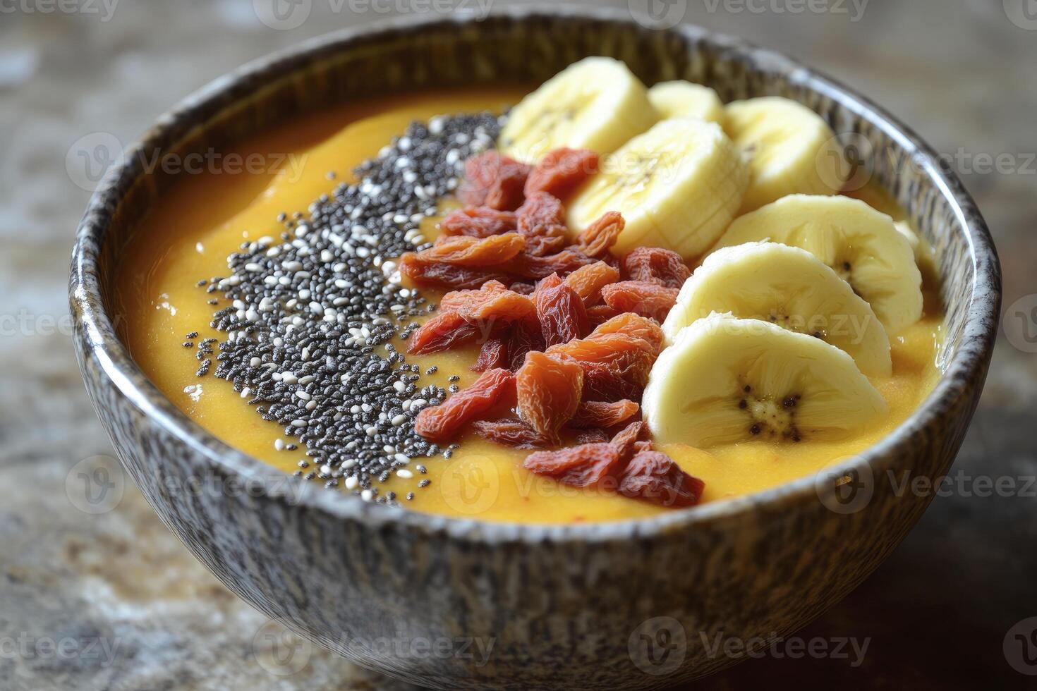 Enjoying a Healthy Smoothie Bowl with Banana, Chia Seeds and Goji Berries photo