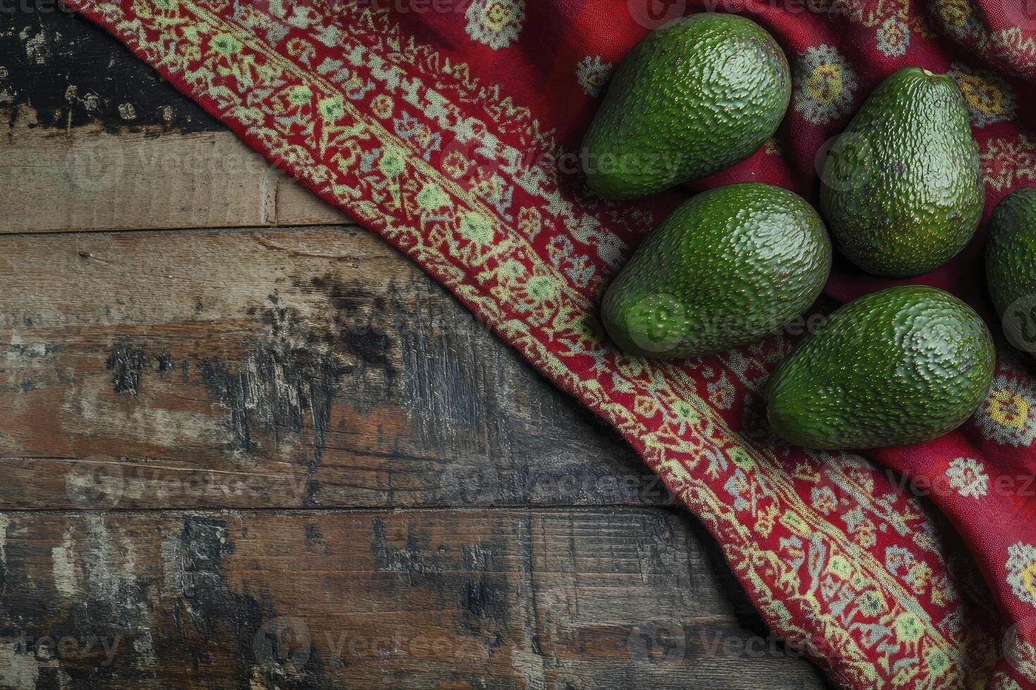 Avocado Fruits on Decorative Fabric and Rustic Wooden Table Surface photo