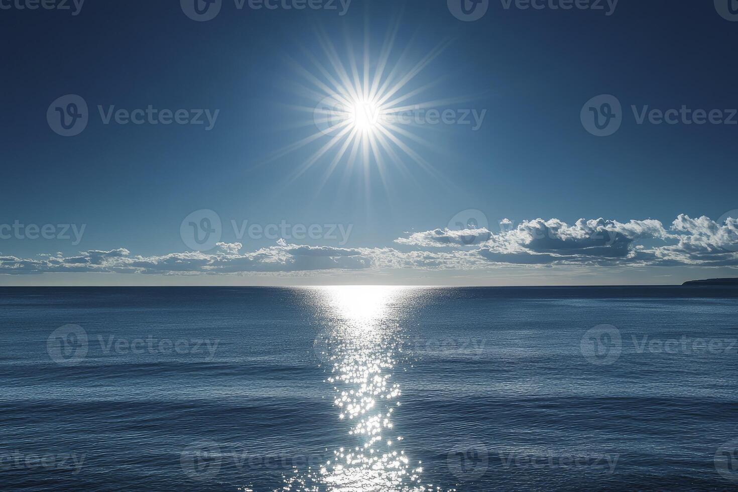 Sunlight Sparkling on Ocean Water with Blue Sky and Clouds photo