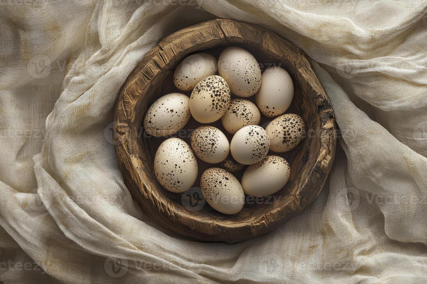 Speckled Eggs in Wooden Bowl on Creamy Fabric Overhead Shot photo