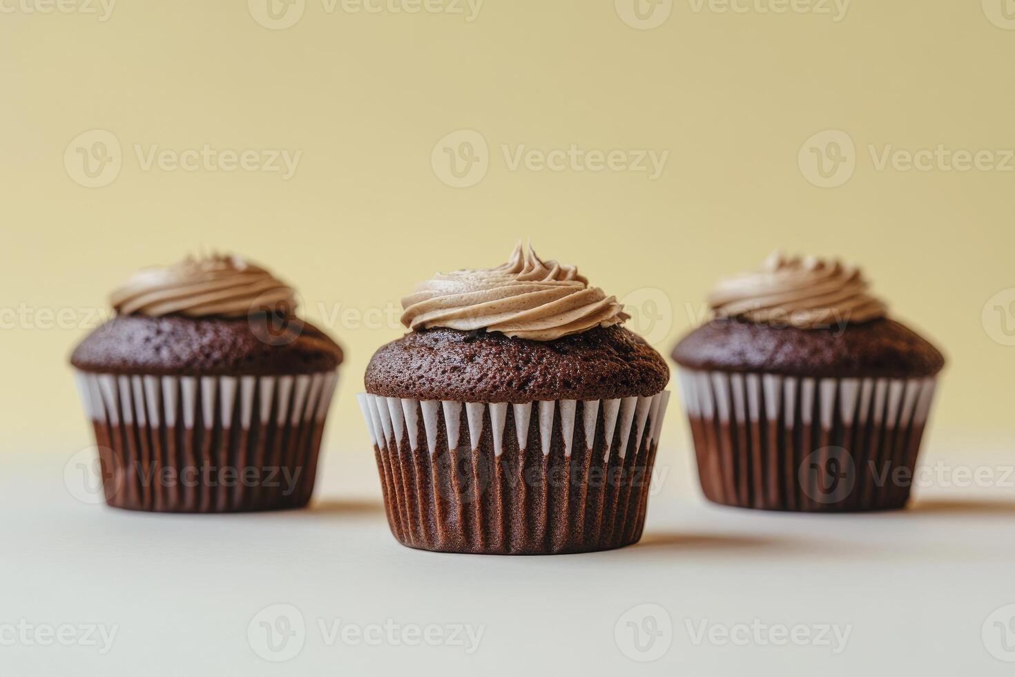 Delicious Chocolate Cupcakes with Cream Frosting on Light Background for Dessert photo