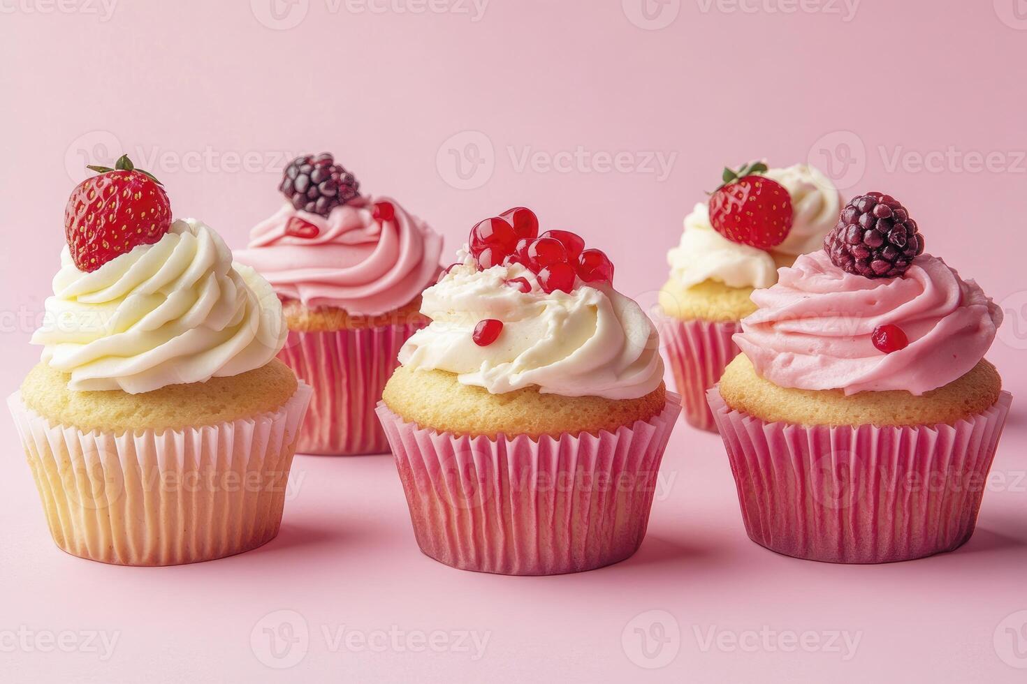 Delicious Cupcakes with Cream and Berries on Pink Background for Dessert photo