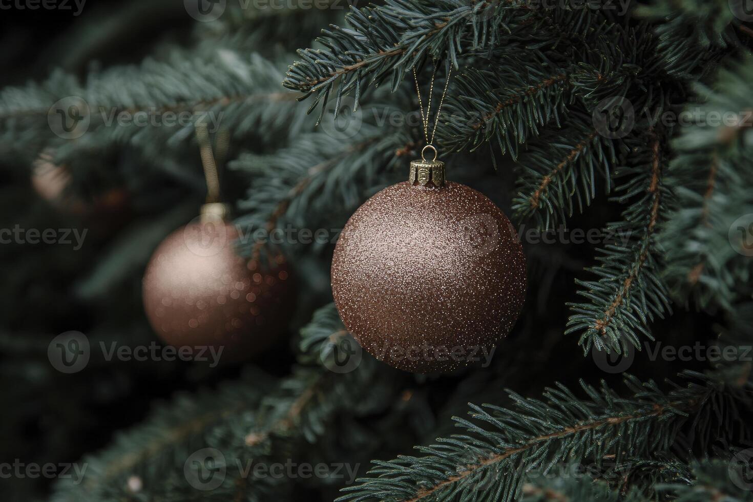 Hanging Bronze Christmas Ornaments on Evergreen Tree Branches Close-up photo