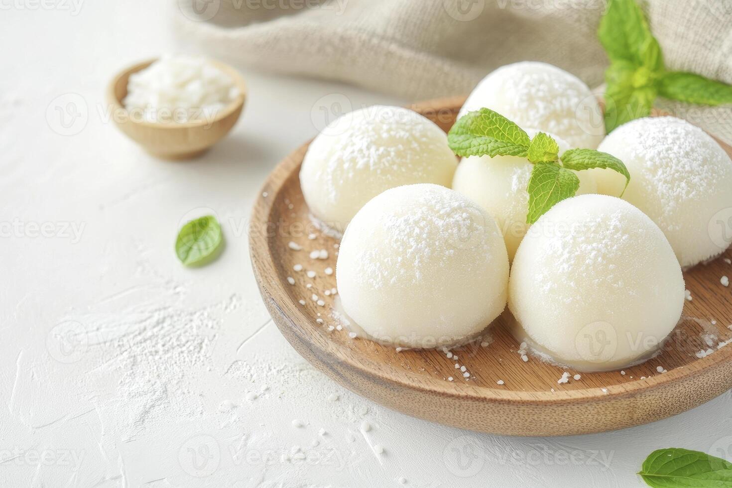 Enjoy Fresh Mochi Dessert on Wooden Plate with Mint Garnish photo
