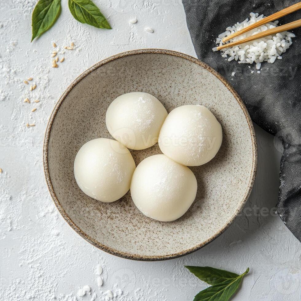 Mochi Ice Cream Balls in Bowl Ready to Eat with Chopsticks photo