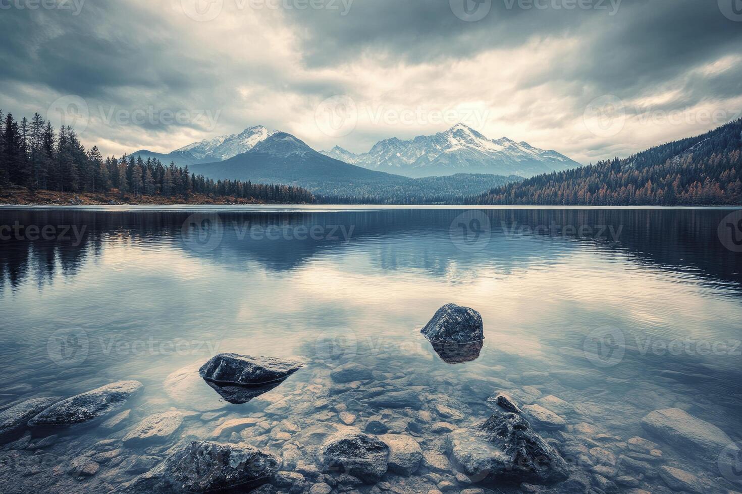 Lake Reflection of Mountains and Clouds with Rocks in Foreground photo