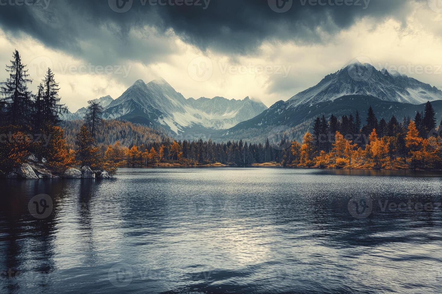 Scenic Lake Reflection of Mountains and Autumn Trees Under Cloudy Sky photo