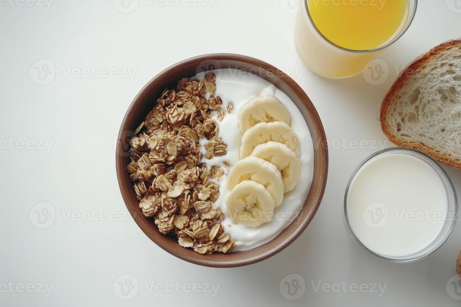 Preparing Granola Yogurt Bowl with Banana Slices and Beverages for Breakfast photo