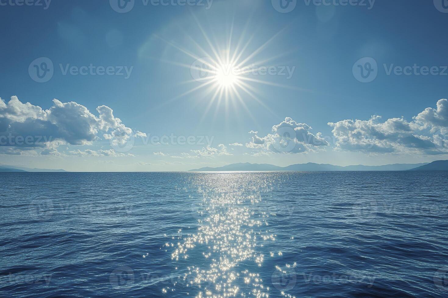 Ocean Water Sparkling Under Bright Sunlight with Blue Sky and Clouds photo