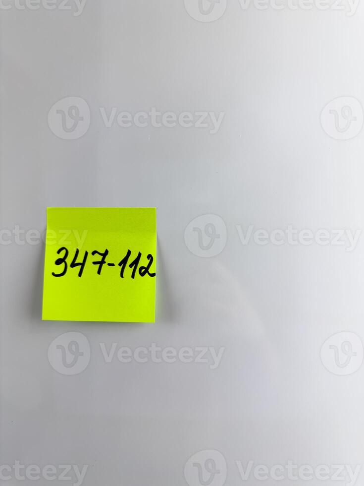 Reminder on refrigerator with the phone number of person photo