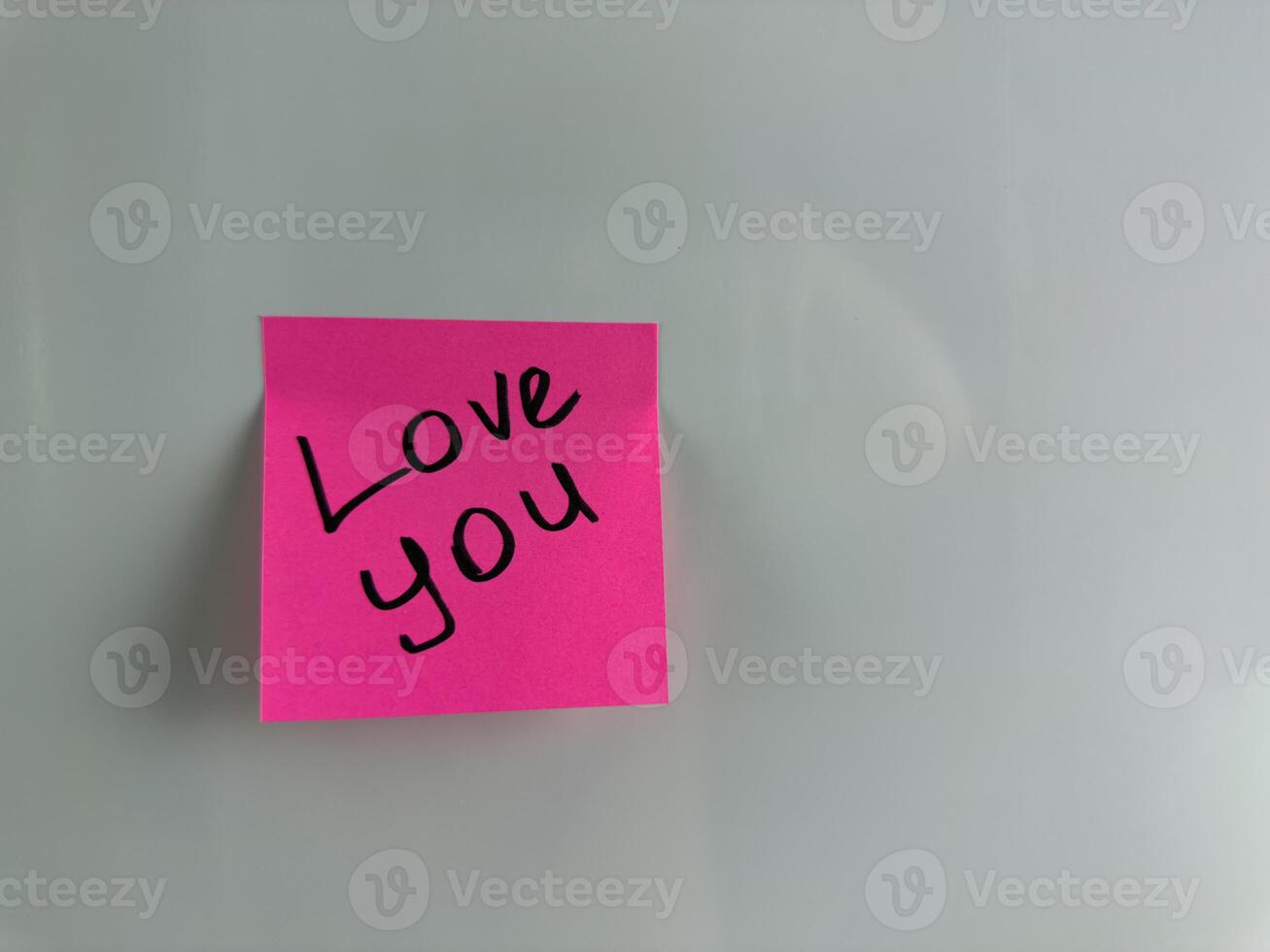 Sweet message with words of love written on sticky note photo