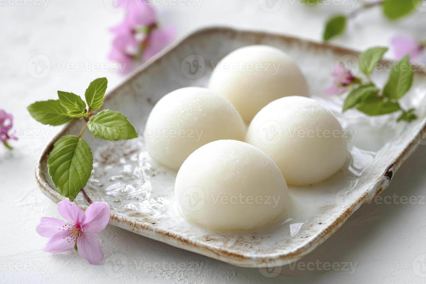 Delicious Mochi Arrangement with Spring Blossoms on Plate for Asian Dessert photo