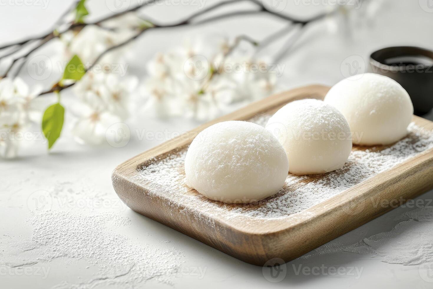 Delicious Mochi Dessert on Wooden Tray with Flour and Floral Decor photo