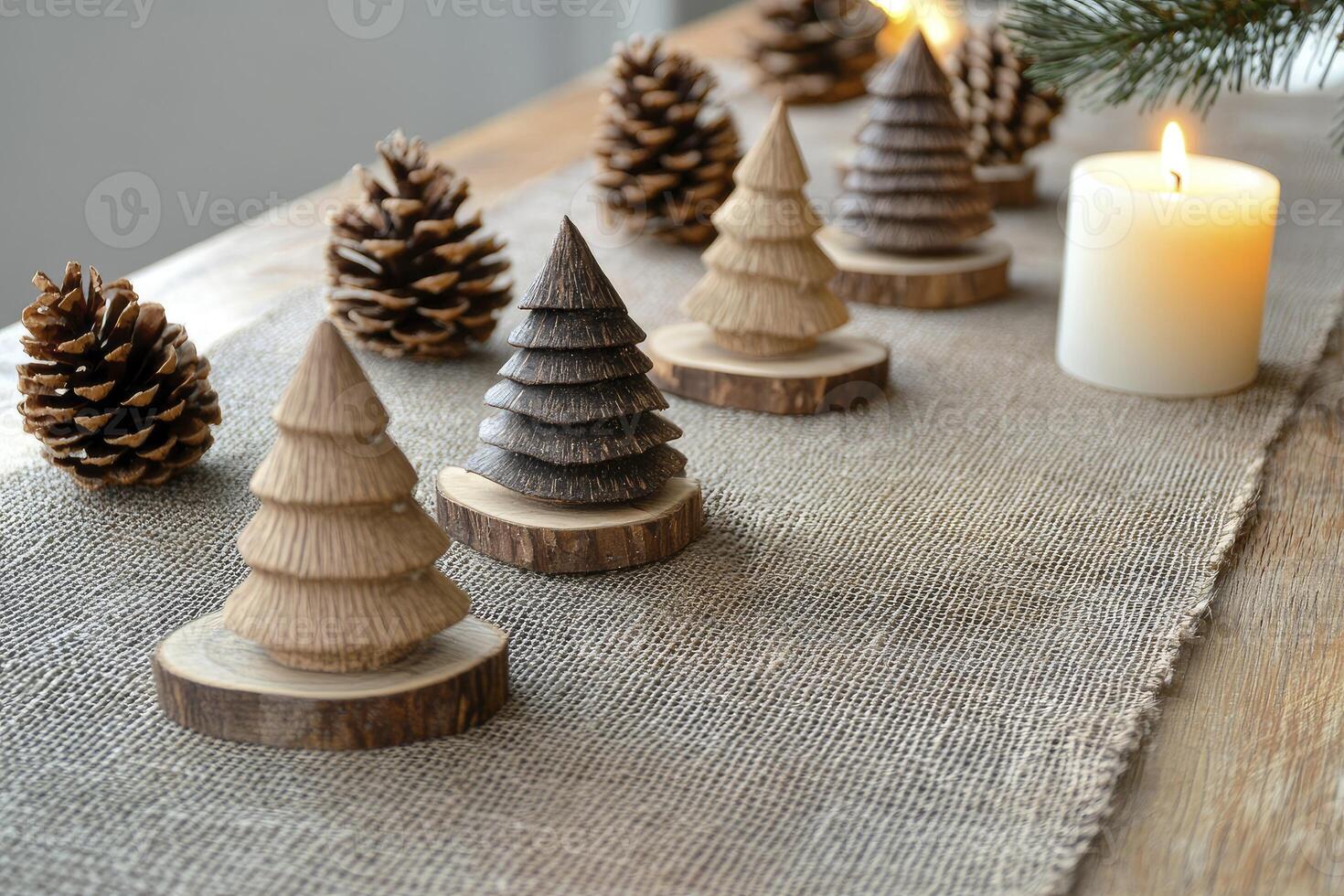 Arranging Wooden Christmas Tree Decorations with Pine Cones and Candlelight photo