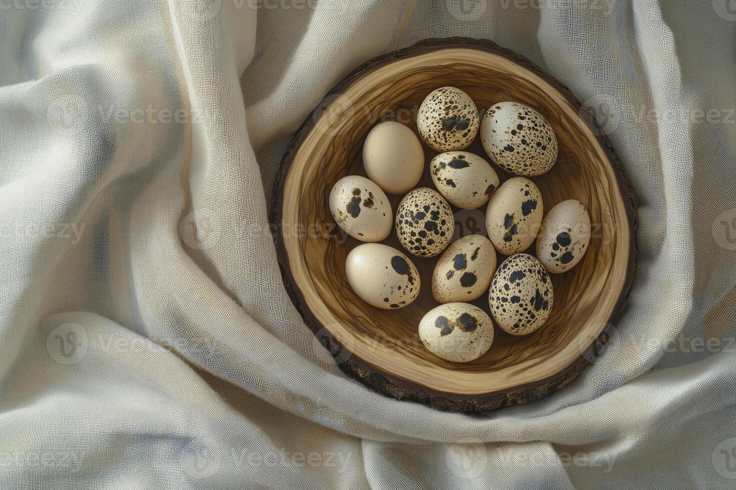 Quail Eggs in Rustic Wooden Bowl on Soft Cream Fabric photo