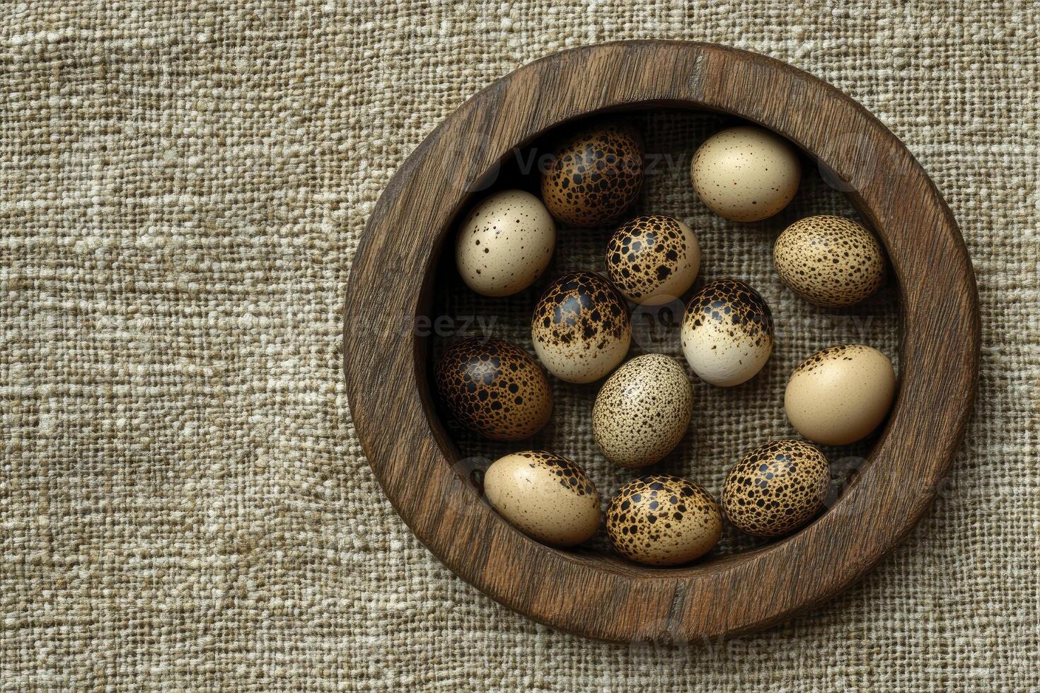 Quail Eggs in Rustic Wooden Bowl on Burlap Background Still Life photo