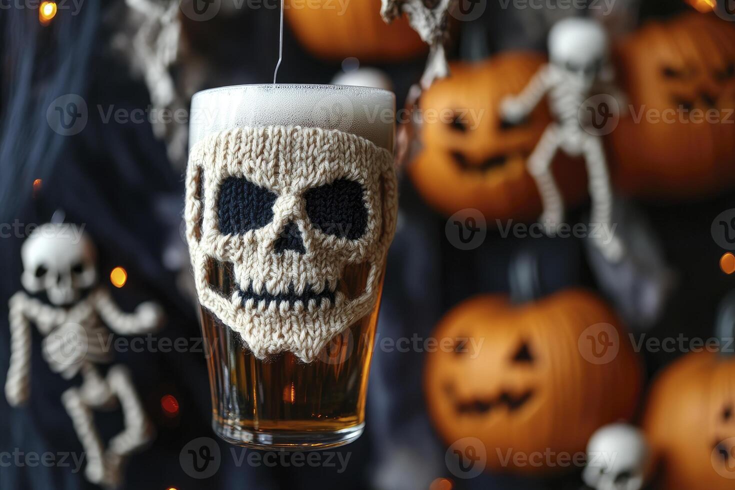 Halloween Beer Glass with Knitted Skull Cozy and Pumpkin Decorations photo