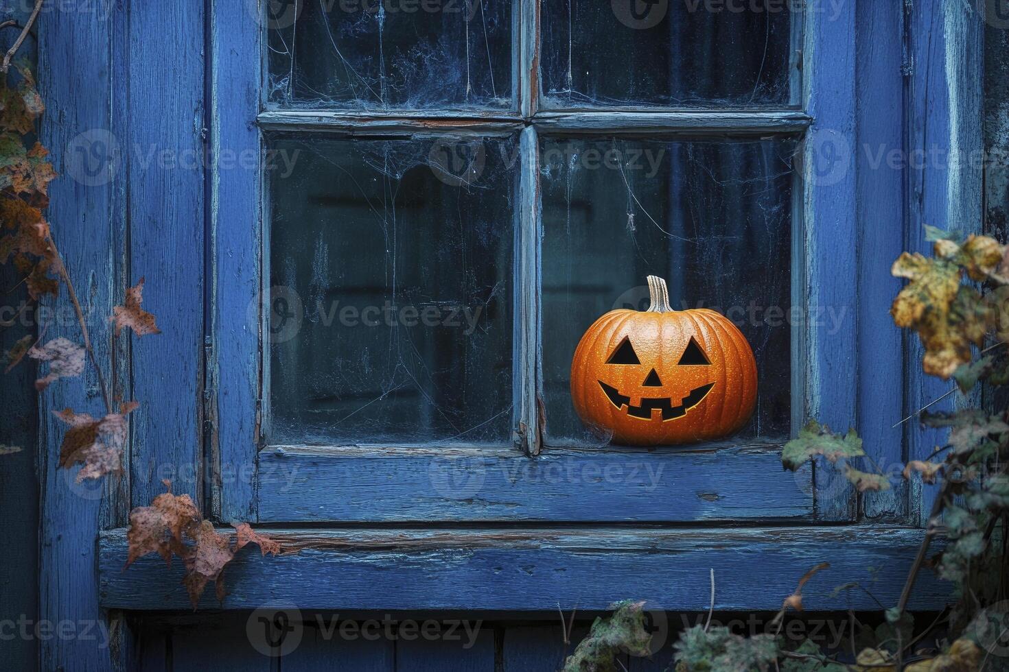 Halloween Pumpkin on Old Window Sill with Vines and Cobwebs photo