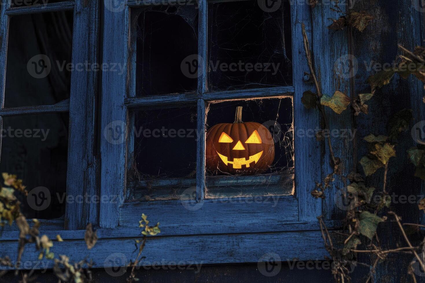 Jack O Lantern Glowing in Window with Dark Creepy Halloween Vibes photo