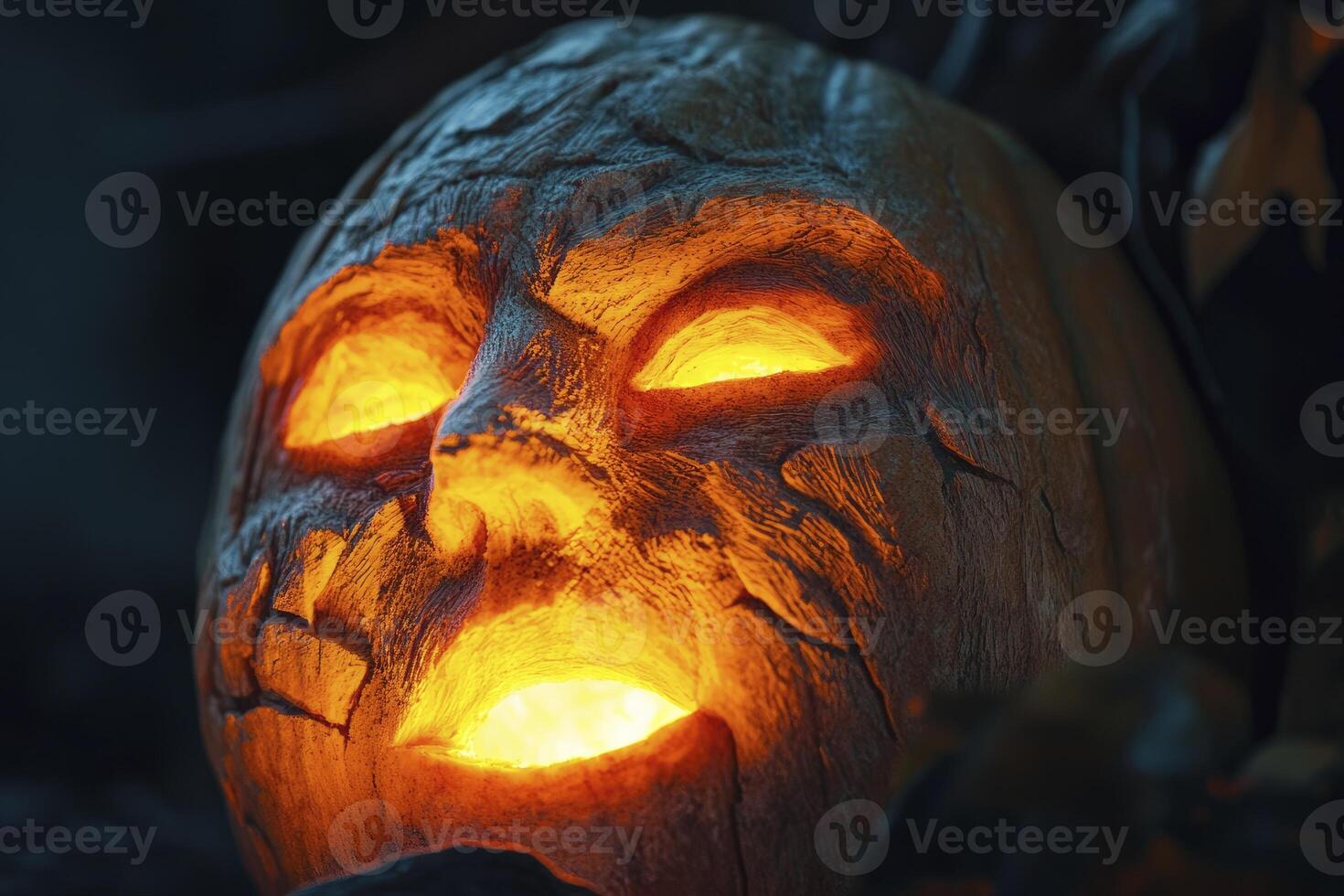 A carved pumpkin with glowing eyes photo