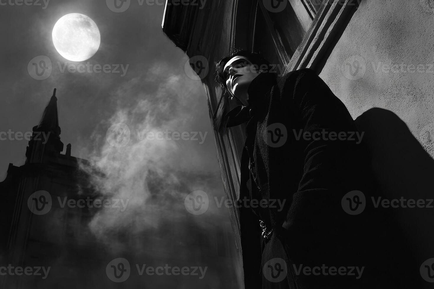 Man in Dark Coat at Night with Gothic Building and Moon photo