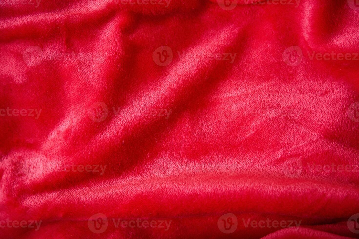 Red shimmering plush fabric colour, close-up texture. photo