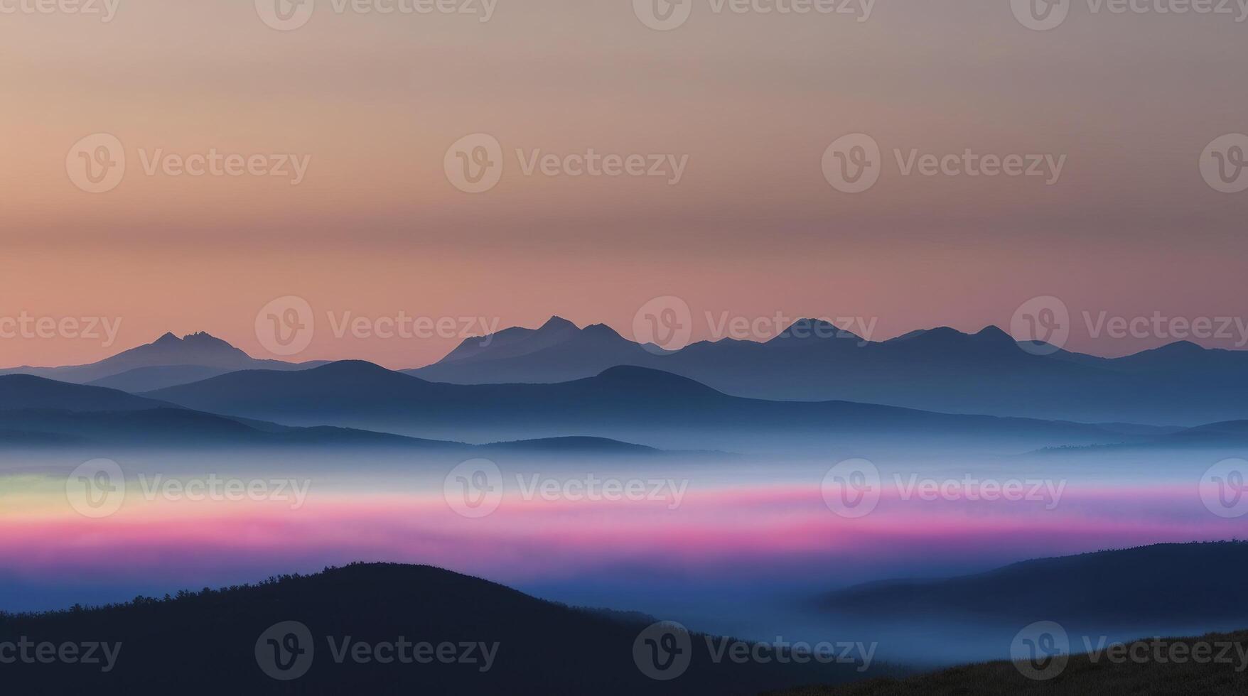 Fog Shrouded Mountain Range at Sunrise with Beautiful Pink Hues photo