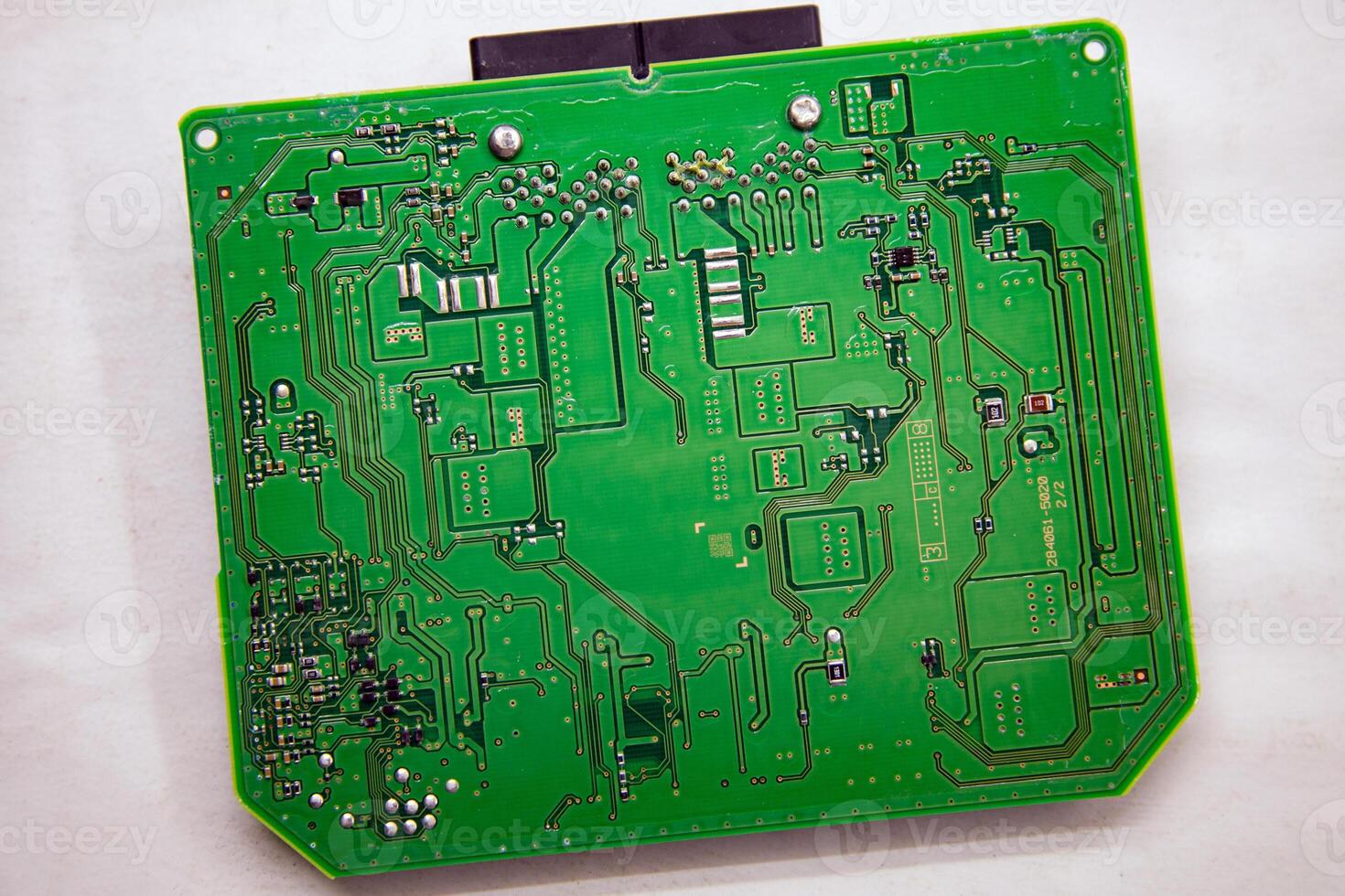 Background and texture of a printed circuit board with microchips and chips from a car safety module photo