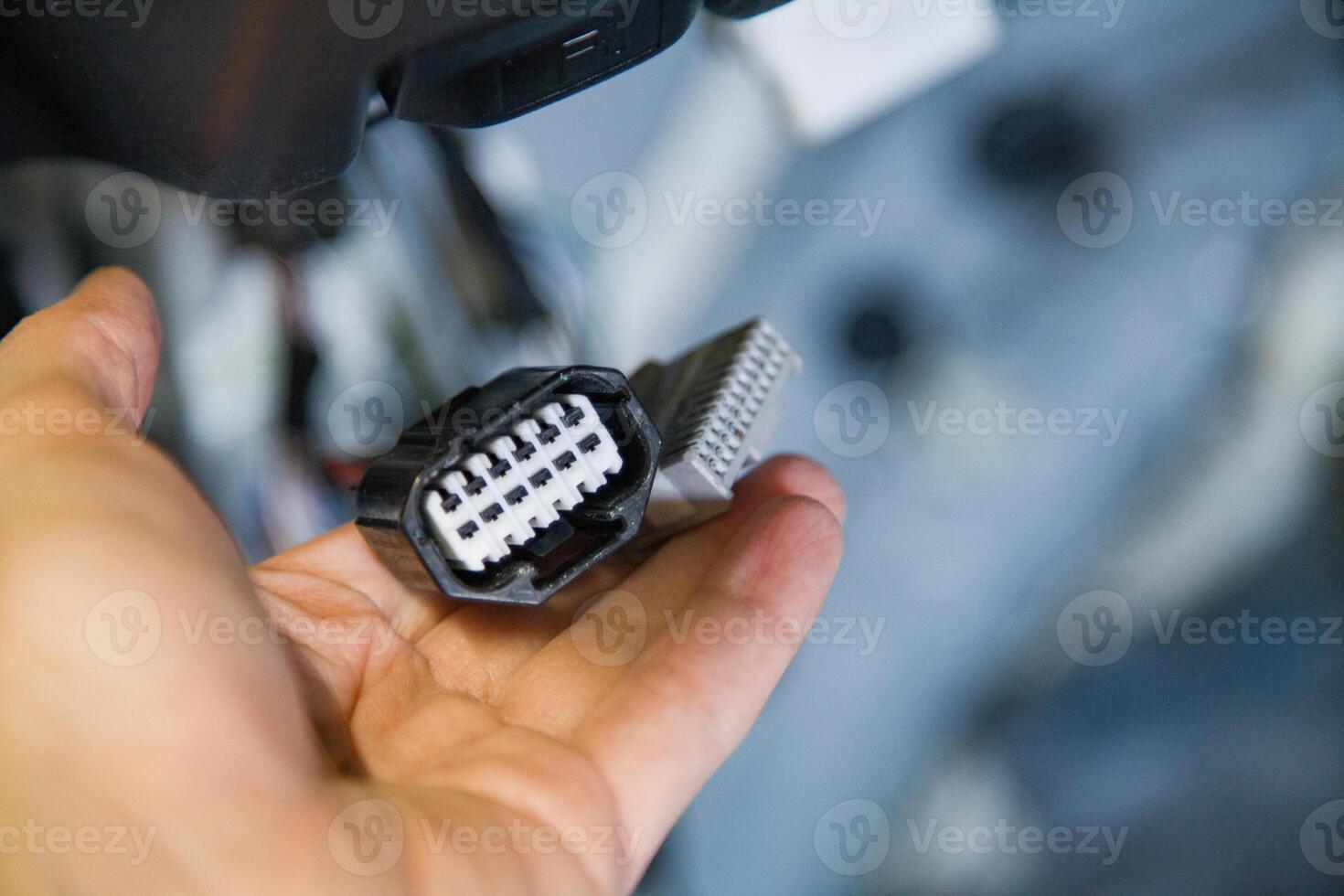 The mechanic holds damaged, oxidized car wiring connector photo