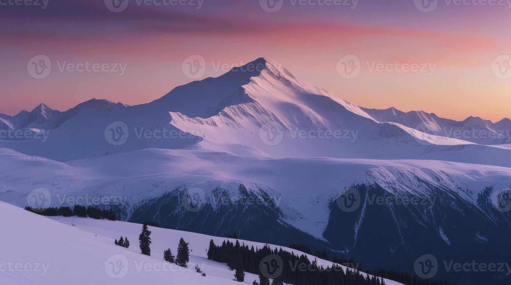 Snowy Mountain Range at Sunset with Pink Sky and Evergreen Trees photo