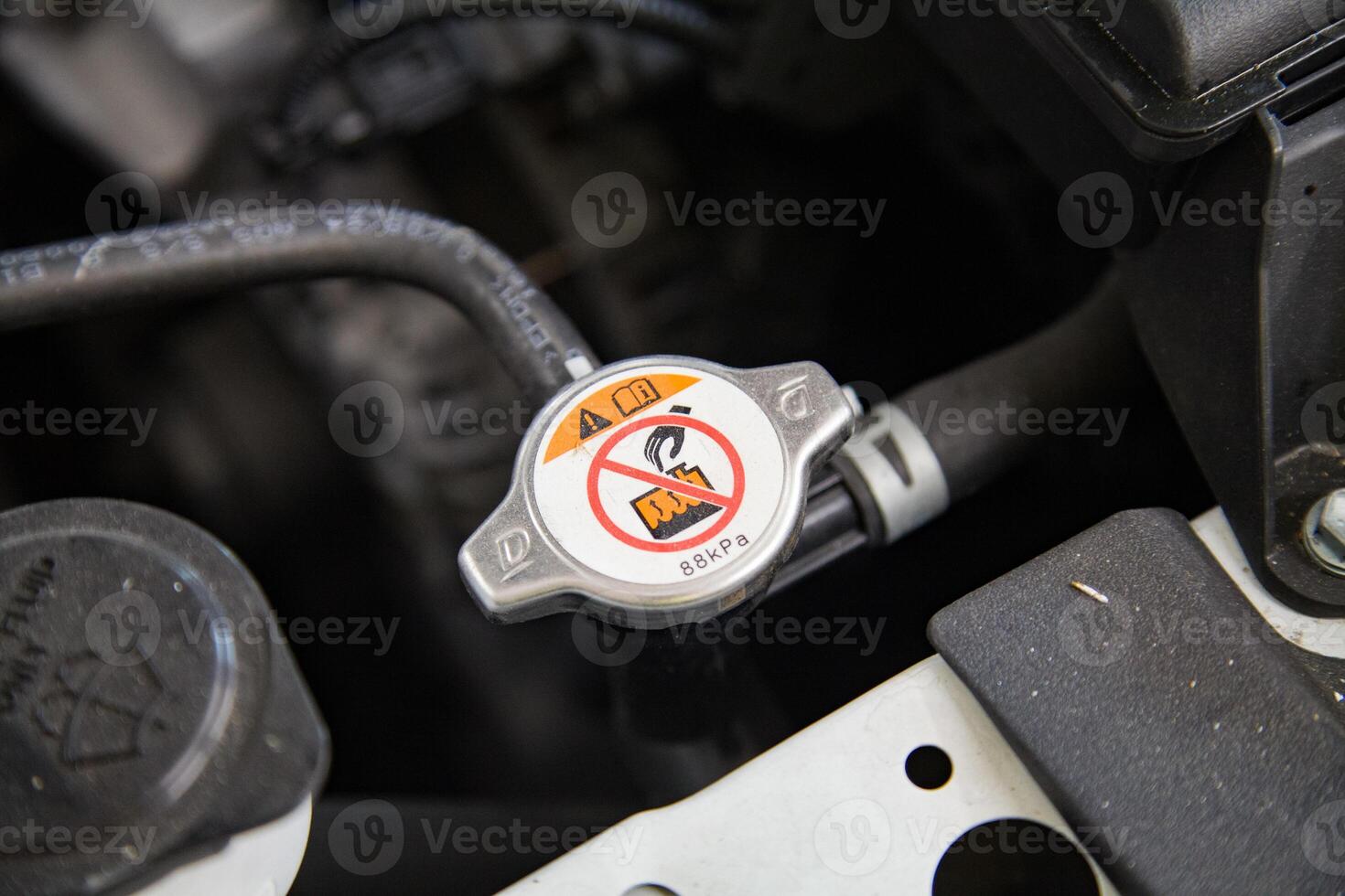Radiator expansion tank cap under the car hood photo