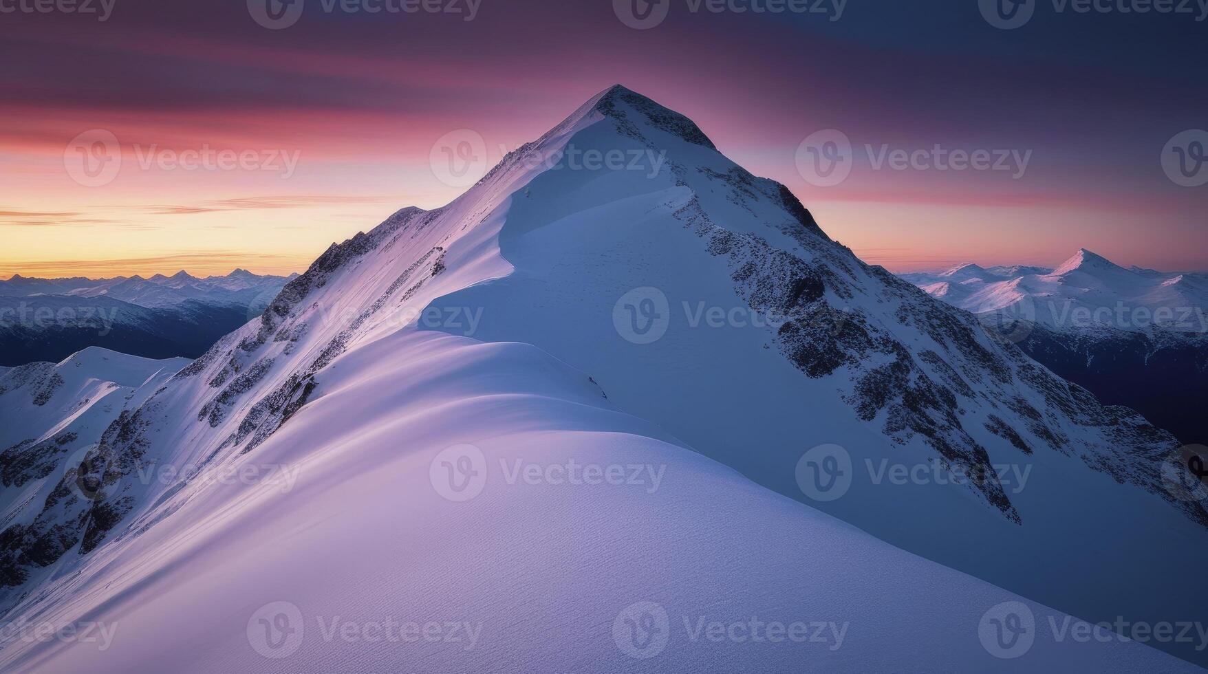 Snowy Mountain Peak at Dusk with Pink Sky in Winter Landscape photo