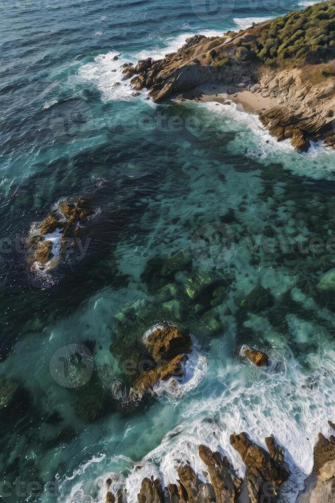 Aerial view of the ocean and rocky coastline in the pacific ocean photo