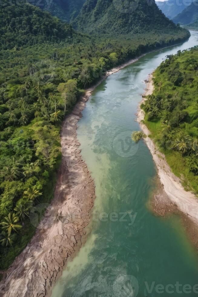 Aerial View of Tropical River Winding Through Lush Green Forest photo