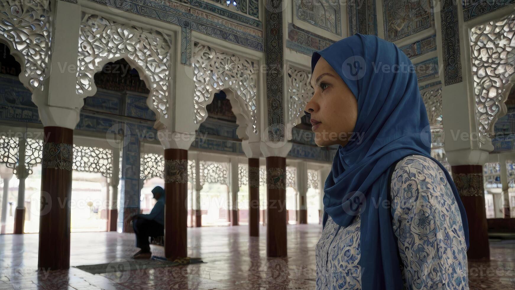 Woman in Hijab Contemplating in Mosque with Ornate Architecture photo