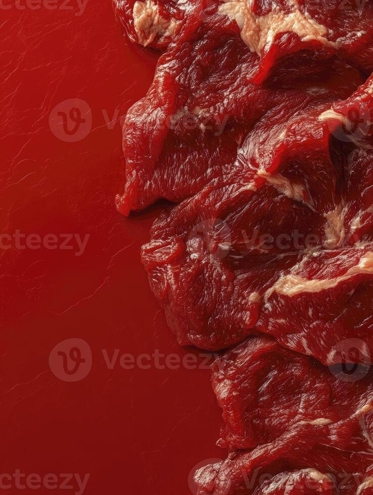 Fresh Raw Beef Meat Cuts on a Red Surface for Cooking photo
