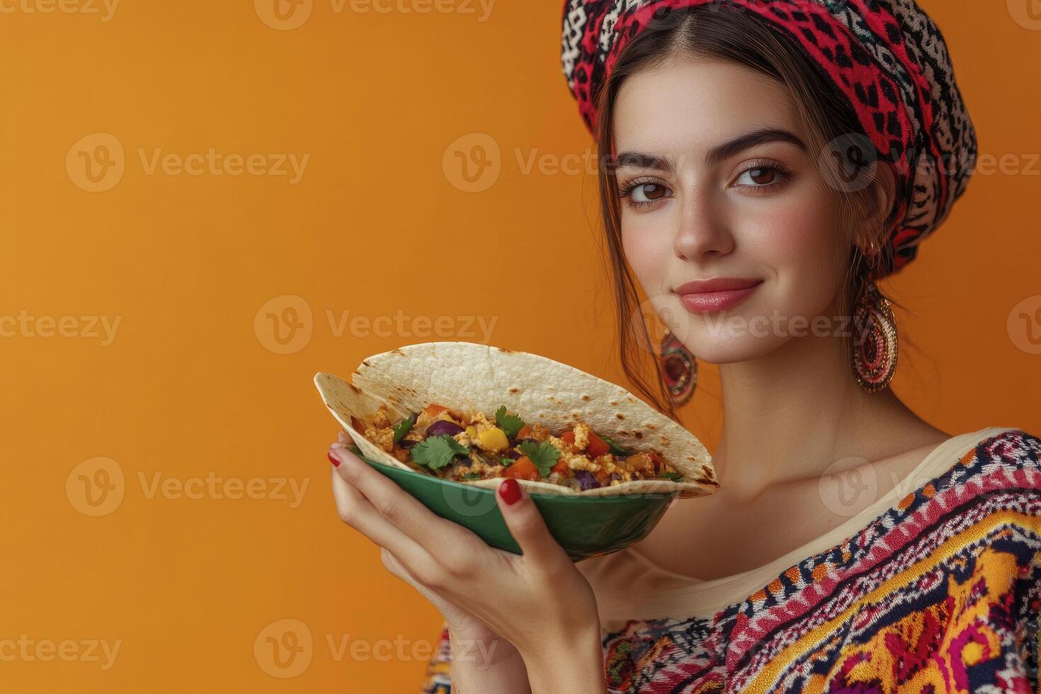 Woman Holding Delicious Taco in Green Bowl Against Orange Backdrop photo