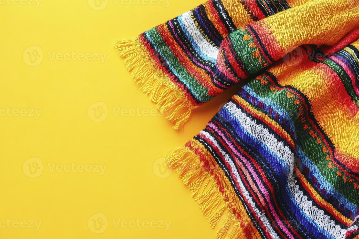 Colorful Striped Blanket with Fringe on Yellow Background for Festive Decor photo