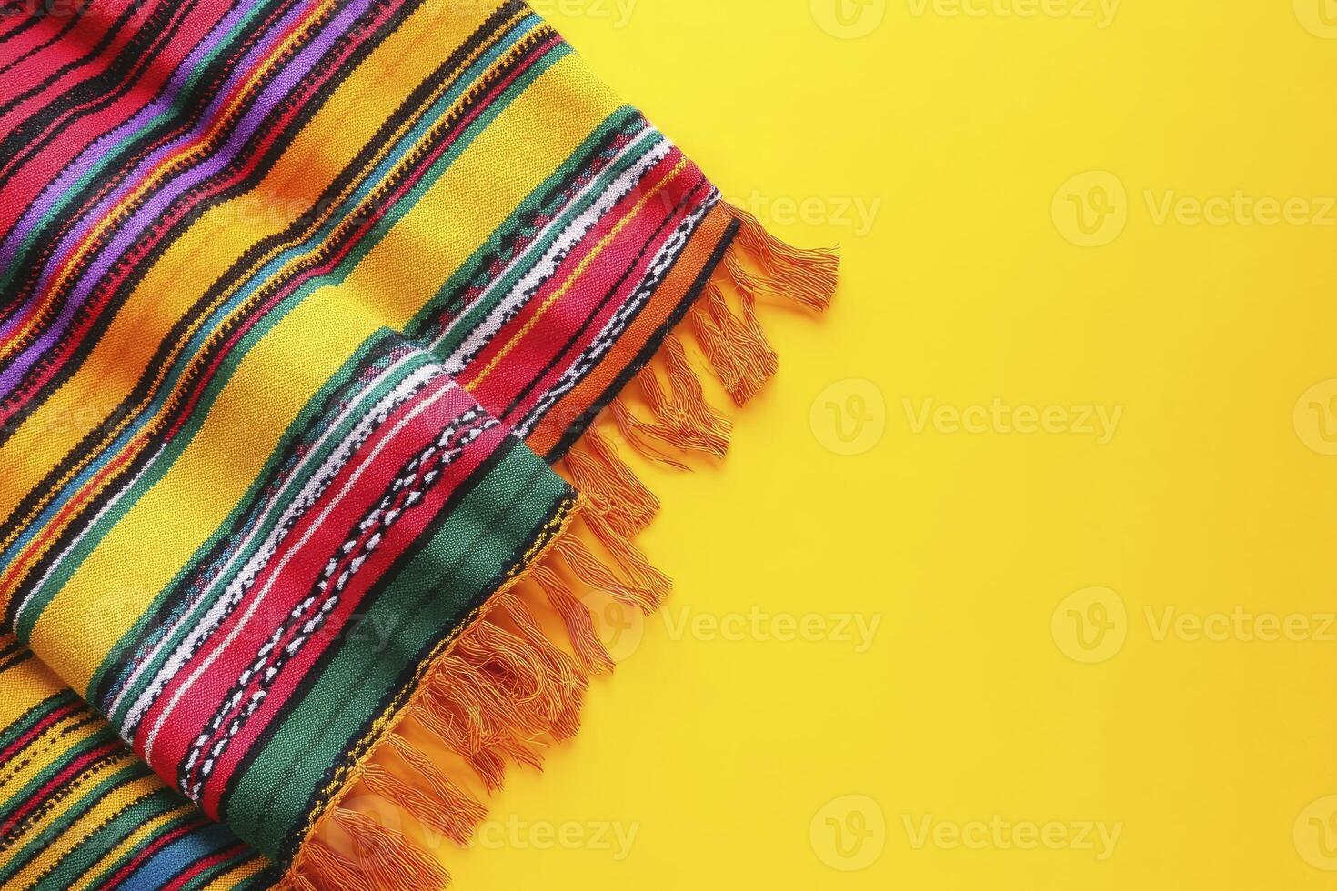 Colorful Striped Fabric with Fringe on Bright Yellow Background Design photo