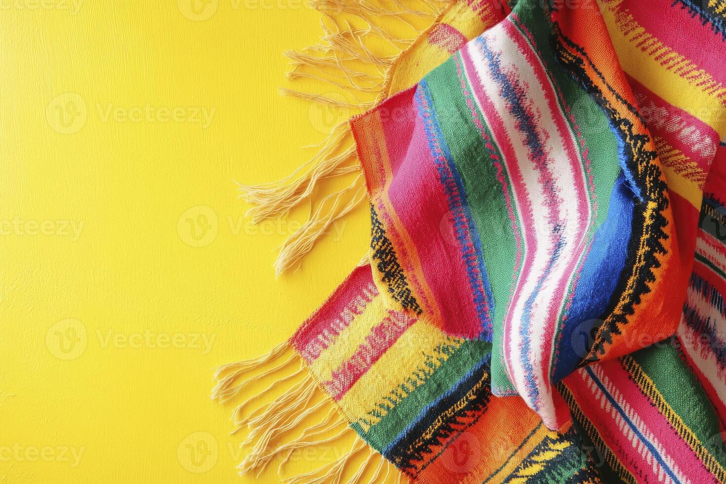 Colorful Striped Mexican Blanket with Fringe on Bright Yellow Background photo