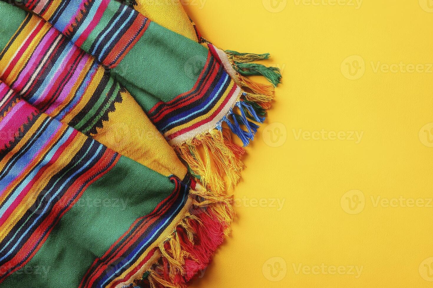 Colorful Striped Blanket with Fringe on Yellow Background Texture Overlay photo