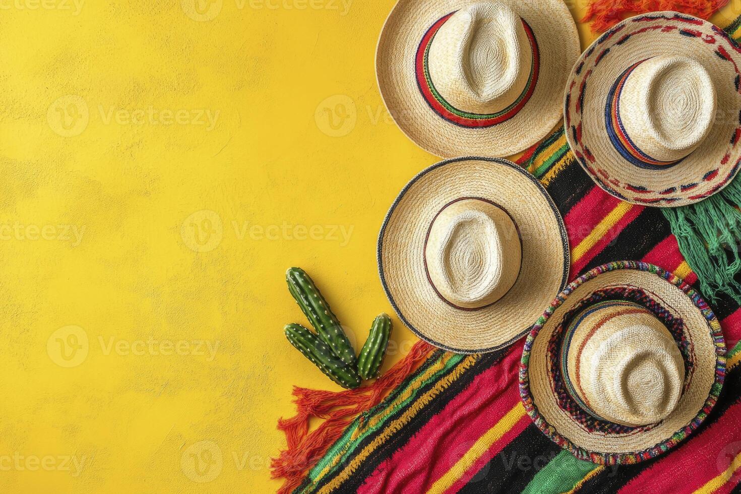 Arrangement of Sombrero Hats with Cactus and Colorful Blanket on Yellow photo