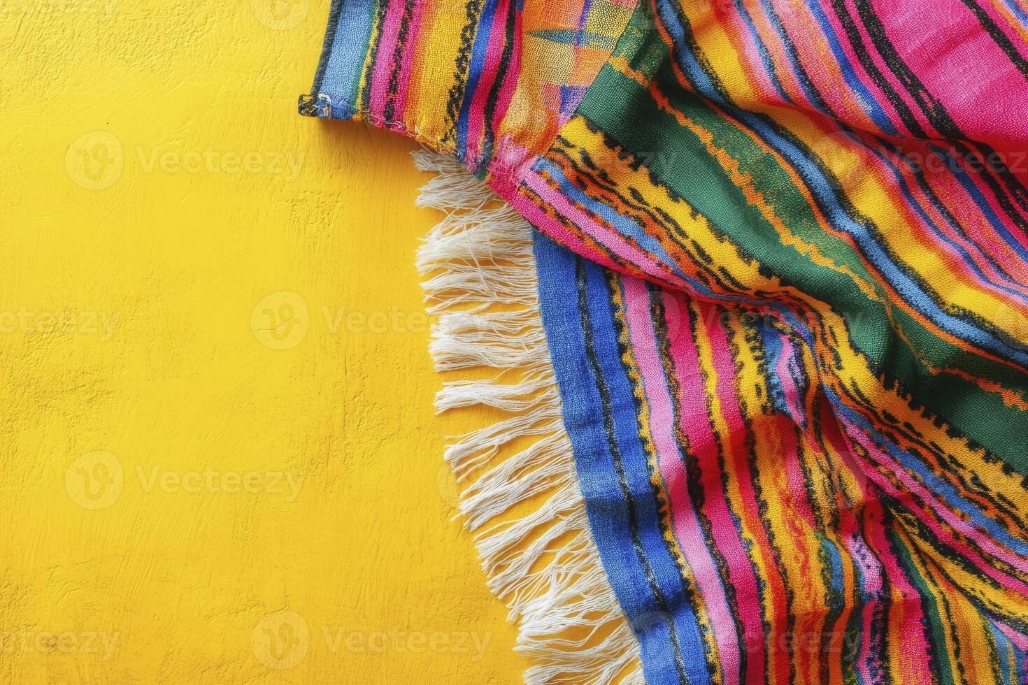 Striped Textile with Fringe on Yellow Background Creates Vibrant Presentation photo