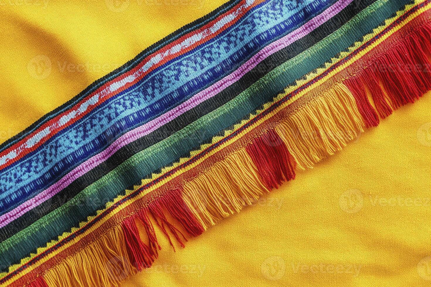 Colorful Embroidered Textile Detail with Fringe on Yellow Fabric photo